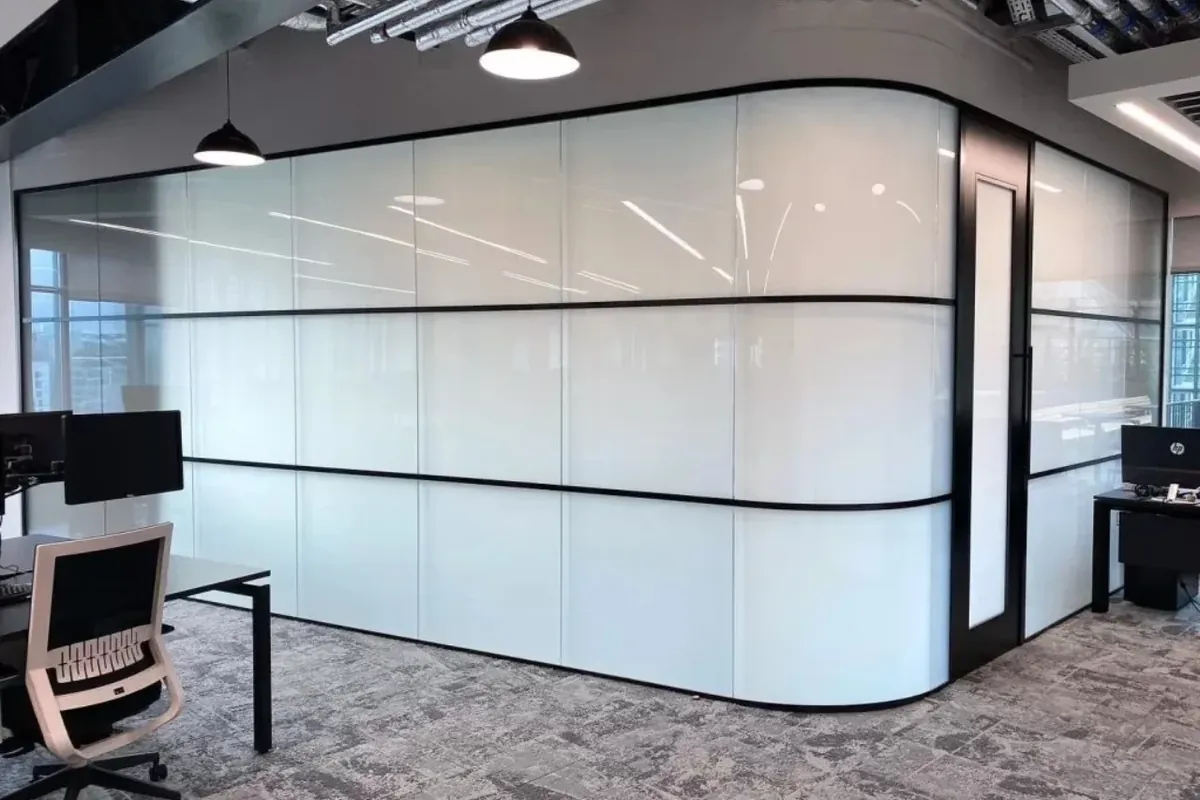 Curved frosted smart glass wall around an office meeting room
