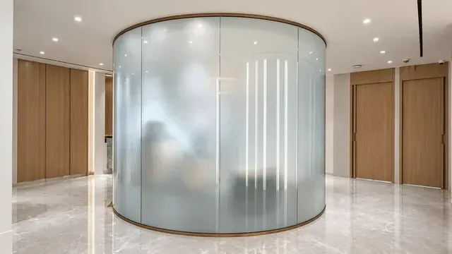 Curved Smart Glass forming a round frosted glass room in a lobby