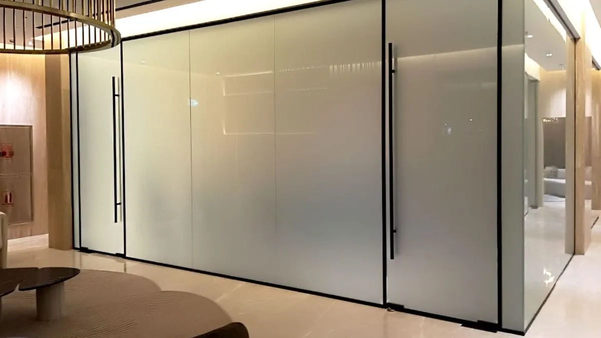 Frosted smart glass partition walls with glass doors in an office